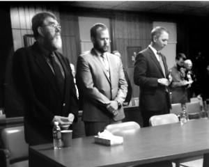 Richard Strzelecki (at left) stands to hear the verdict of the jury.