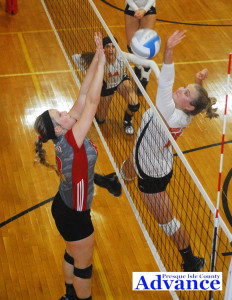 Onaway setter Taylor Ehrke and Rogers City hitter Sarah Meredith battle for a point at the net during last week's Presque Isle County championship. (Photo by Peter Jakey)