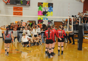 Both Rogers City and Onaway fans represented their schools well at the district finals. Here the Huron fans storm the court after Rogers City won the match. (Photos by Richard Lamb)