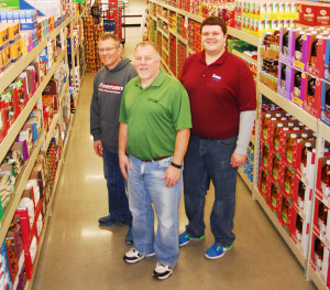 ROGERS CITY’S Save-A-Lot opened Saturday in the heart of downtown Rogers City. Pictured are, from left, owners Tom and Tim Freeman, and store manager Josh Martinez. (Photo by Peter Jakey)