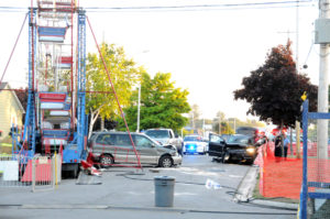 The driver of a Ford SUV is questioned at the scene of an accident Wednesday night at the Nautical City Festival. According to witnesses the black Ford slammed into the van, which then was pushed into the Ferris wheel. (Photo by Richard Lamb)