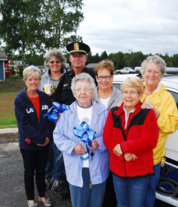 GATHERED AROUND Rogers City police chief Matt Quaine are the ladies involved in collecting more than $1,700 in donations. They include, from left, Kim Margherio, Annette “Chops”  Maynard, Joyce Zemple, Linda Scranton, Lee Bingle and Beth Getzinger.  (Photo by Peter Jakey)