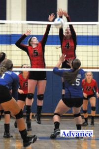 Onaway's Vydailya Letts (4) tied a school record with 6 blocks in a match. Here she teams with Jaclyn Nash to stop an attack. (Photo by Richard Lamb)