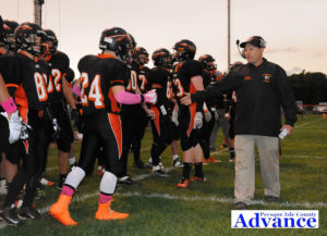 Huron varsity football coach Cory Malocha greets his players as they are introduced by public address announcer Erik Nadolsky before Friday'<div class='adsense adsense-bottom' style='float:right;margin:12px'><figcaption id=