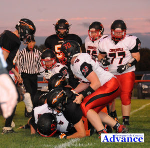Huron defenders team up to gang tackle a Whittemore-Prescott runner in Friday's game. (Photo by Richard Lamb)