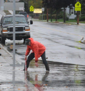 City workers worked quickly to clear storm drains during Monday's quick, heavy rain storm. (Photo by Richard Lamb)
