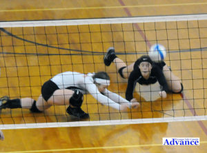 Mary Brege and Jayna Hance hit the floor to make a dig of a ball in the district championship match.
