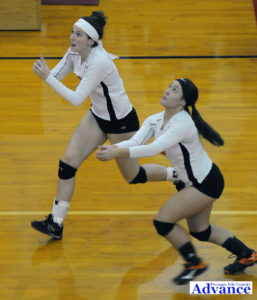 Veronica Szczerowski and Erika Peacock make a run for the ball during Friday's district championship match. (Photo by Richard Lamb)