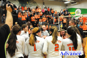 A joyous team celebrated a win as their fans cheer in the stands. (Photo by Richard Lamb)
