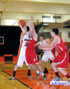 Rogers City's Phil Grambau drives on Posen's Robert Fisher in action on the hardcourt Dec. 8. (Photo by Richard Lamb)