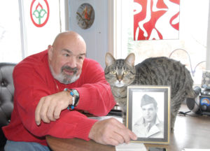 JAMES B. NOKES (left) is the proud son of World War II veteran, James W. Nokes, and does not plan to give up the fight to get his father a Purple Heart for wounds suffered in Central Europe. George, a faithful feline, is credited with extending James W.’s life by at at least two years. He loved his owner, and has no trouble posing in a photo with the war hero. (Photo by Peter Jakey)
