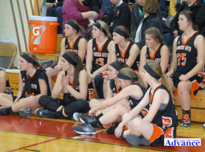 Dejected players from the Huron girls' basketball team watch as Hillman receieved its its' district title hardware. (Photo by Peter Jakey)