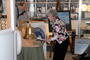 BETTY DEMBNY took part in Saturday’s bell-tolling ceremony in Rogers City. Here she rings the bell in honor of wheelsman Stanley Haske, her husband at the time of the disaster. He was one of the 10 men who died that day. (Photo by Peter Jakey)