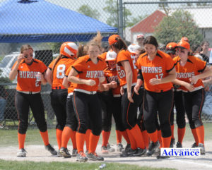 Mighty Mary Brege is surrounded by her teammates after she blasted a homer in the district championship game. (Photo by Richard Lamb)