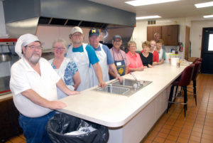 THE SOUPER Duper Soup Kitchen is back in business in Onaway. This was the crew working in the kitchen of the St. Paul Catholic Church Hall, Aug. 16. Pictured from left are Glen and Rita Lunceford, Jim Suchey, Dave DeLauder, Ray Tovar, Faye Gee, Pat Vermilya, Shelly Lunceford, Maxine DeLauder and Greg Diller. Glen said it is a great group of volunteers, that without them, it would not be a success. (Photo by Peter Jakey)