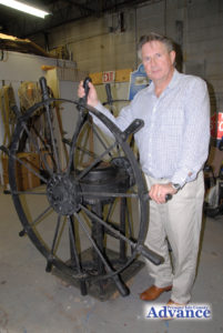 LOCAL ATTORNEY Erik Stone stands with a ship’s emergency wheel that has been in his family for decades. It will be part of the beautification project at the intersection of Third and Erie streets. The entire project will be dedicated, Oct. 7 at 2 p.m. (Photo by Peter Jakey)
