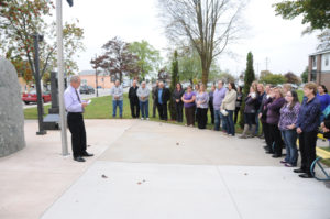 Judge Donald J. McLennan stand before a group of courthouse employees gathered to remember register of deeds Kathy Karsten who passed away Oct. 12. 