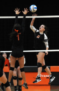 Huron middle hitter Shawna McDonald tips for a point in the district semifinal win over Hillman. (Photo by Richard Lamb)