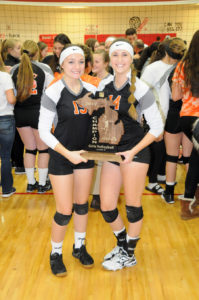 Senior co-captains Hannah Fleming and Kayla Rabeau shared a moment with the regional trophy after their team topped Bellaire. (Photos by Richard Lamb)