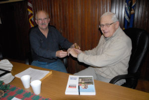 OUTGOING ONAWAY mayor Gary Wregglesworth passes along the gavel to his successor Chuck Abshagen, who will take over after the first of the year. (Photo by Peter Jakey)