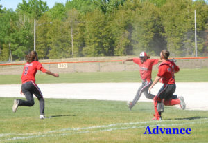 Cardinal players celebrate the final out of the game giving the team its second consecutive district title. 