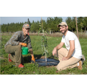 NICK JOHNSON, farm owner, and James DeDecker, Michigan State University Extension educator, spent much of their Saturday planting chestnut trees in Moltke Township. (Photo by Peter Jakey)