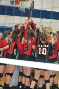 An emotional Onaway Cardinals' volleyball team hoisted the regional championship trophy high after a thrilling victory. 