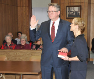 WITH HIS wife Meg at his side, Erik J. Stone is sworn in as the next judge of probate court for Presque Isle County. (Photo by Peter Jakey)