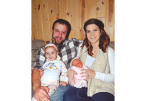 THE PEACOCK family of Rogers City is off to a good start in 2019. Greg and Judy gave birth to Presque Isle County New Year’s baby. Baby Stella Jane is held in the warm, loving arms of her mother. At left, big sister Olivia, who has a birthday next week, is super excited about her new role. (Photo by Peter Jakey) 