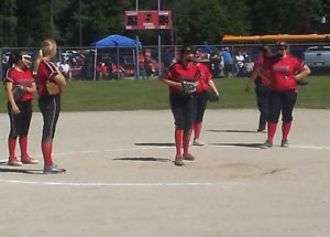 Cardinal players celebrate an out in the opening game of the East Jordan regionals. (Photo by Peter Jakey)