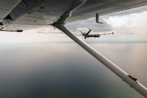 A Cessna 206 Stationair mission crew with the Civil Air Patrol’s Michigan Wing escorts a MQ-9 Reaper assigned to the 214th Attack Group, Arizona Air National Guard, over Alpena, Mich., during a training sortie during Northern Strike 19, July 24, 2019. The Civil Air Patrol is responsible accompanying remotely piloted aircraft to and from restricted areas within U.S. airspace in order to meet Federal Aviation Administration safety requirements (U.S. Air National Guard photo by Tech. Sgt. Lealan Buehrer).
