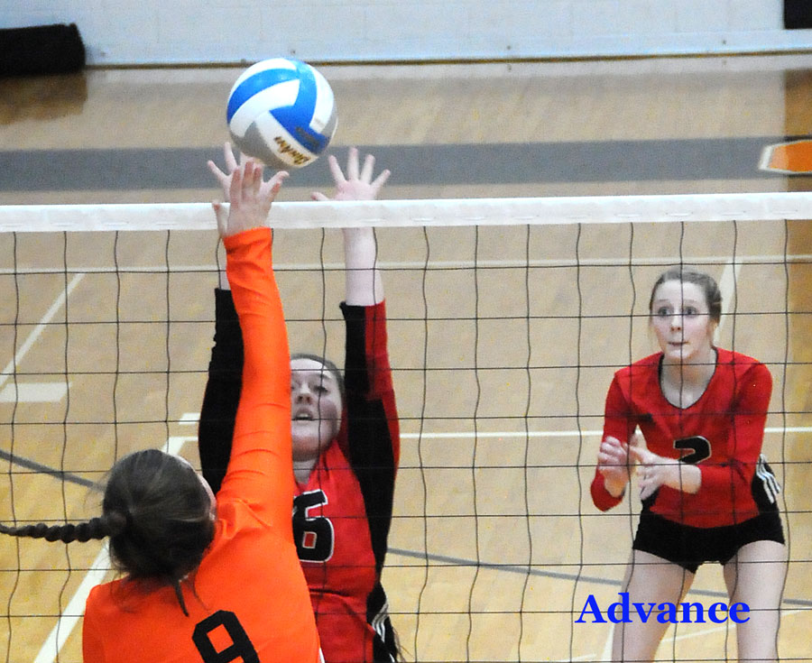 Senior outside hitter Jackie Sellke wins this battle at the net with a Rudyard attacker. (Photo by Richard Lamb)