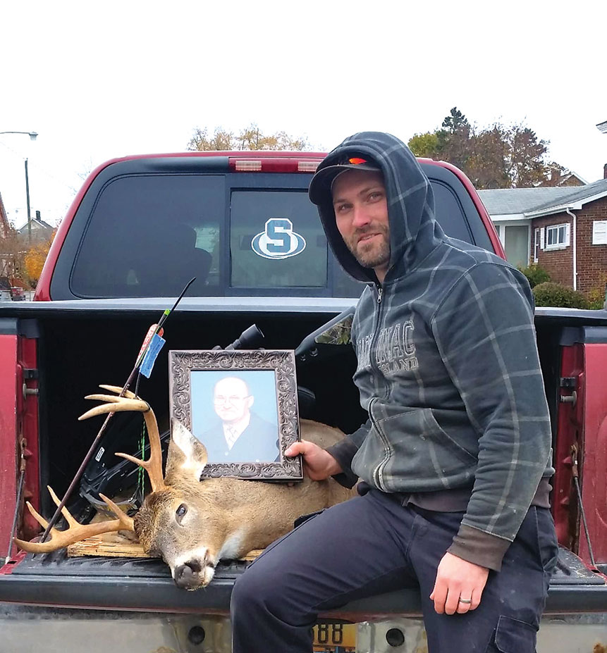 AVID HUNTER Dwayne Olden, who is proud of his hunting roots, displays a picture of his late grandfather Leo Boyk with the 8-point buck he got last week. 