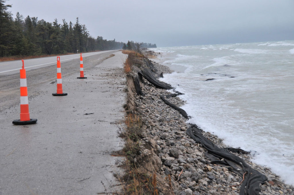 SEVERE EROSION undermines the edge of the Huron Sunrise Trail pavement, and approaches the road bed of U.S.-23 Highway just south of P.H. Hoeft State Park. (Photo by Mary Ann Heidemann)