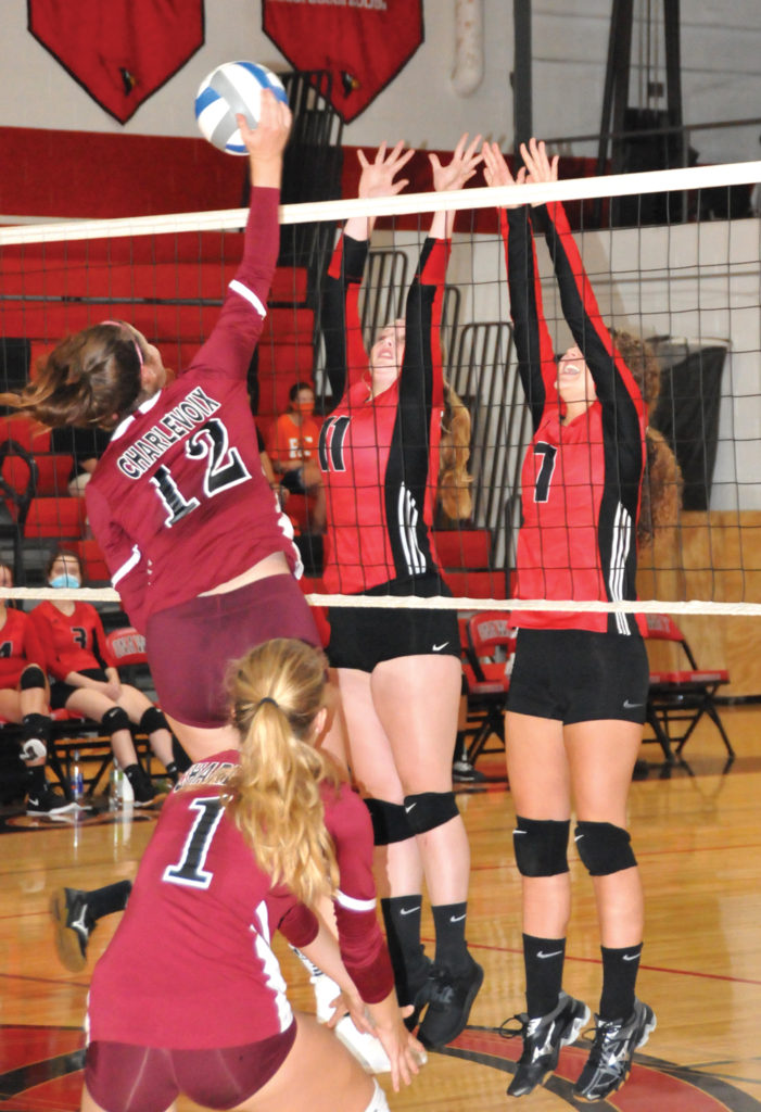 PROVIDING A block attempt for Onaway are juniors Lexie Horton (left) and Ellie Enos. (Photo by Peter Jakey)