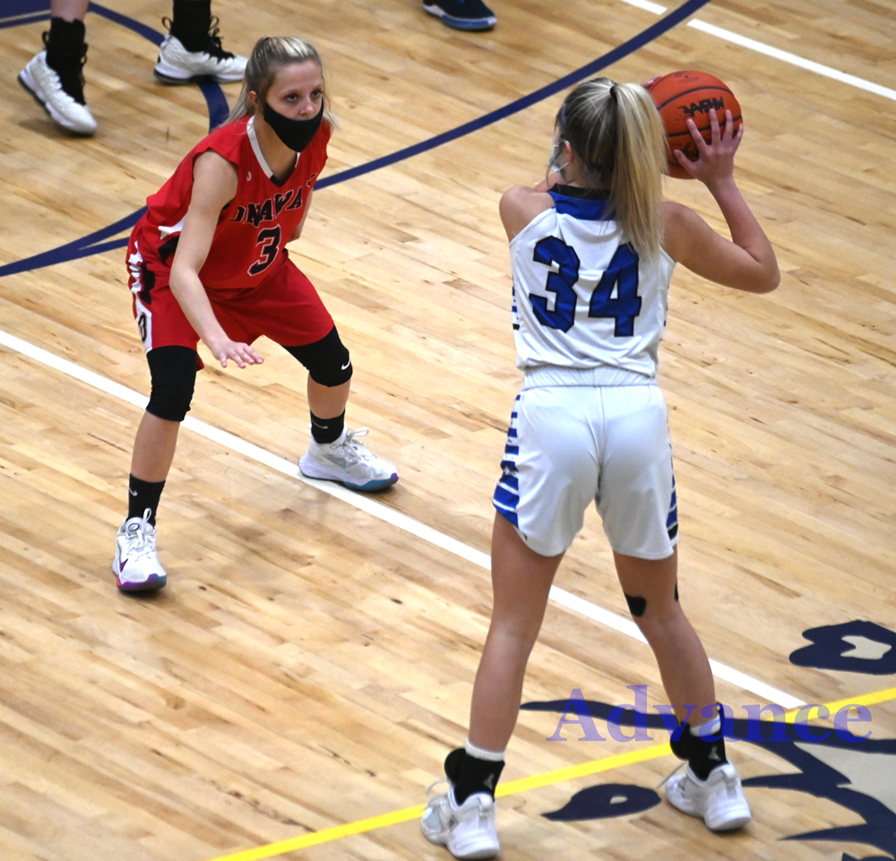 Onaway's Taylor Larson digs in on defense of Inland Lakes guard Olivia Monthei. 