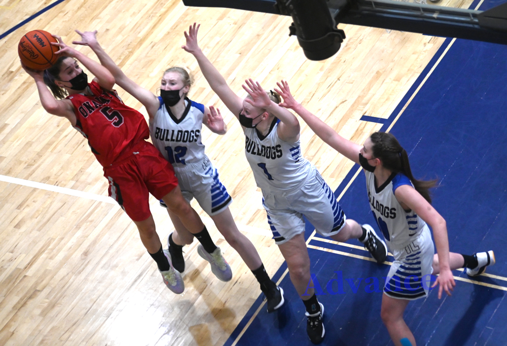 Madilyn Crull finds herself triple-covered while attempting this shot in Onaway's win over Inland Lakes. 
