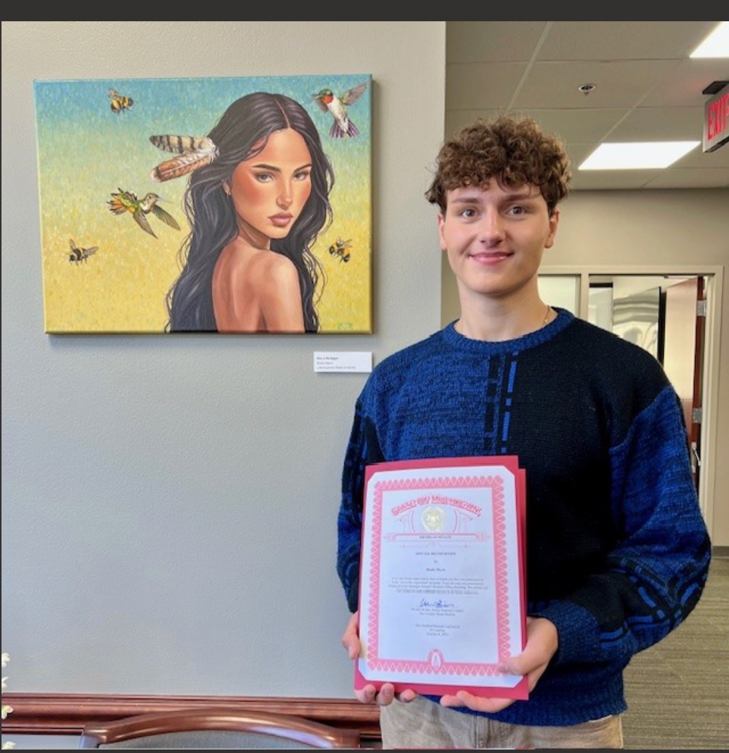 Brady Myers with his painting in Lansing.