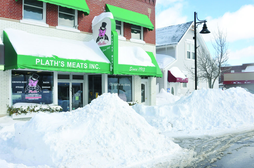 THE WEEKEND brought loads of snow that piled up in front of houses and businesses as residents scrambled to find a way out. Here Plath’s Meats cleared a tunnel to get to the front door. (Photo by Richard Lamb)