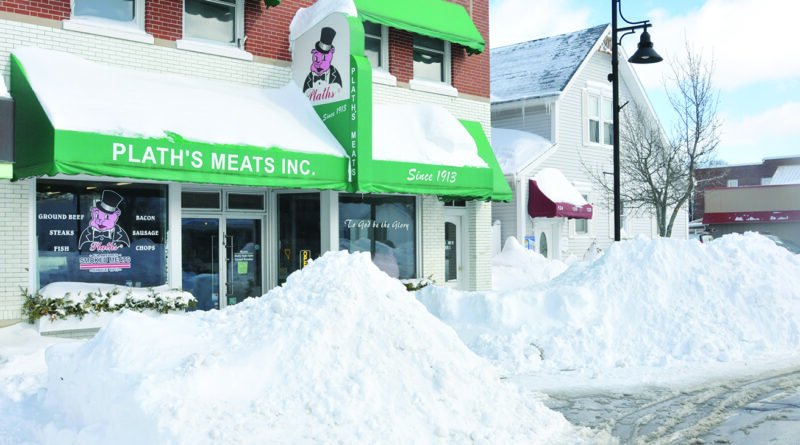 THE WEEKEND brought loads of snow that piled up in front of houses and businesses as residents scrambled to find a way out. Here Plath’s Meats cleared a tunnel to get to the front door. (Photo by Richard Lamb)